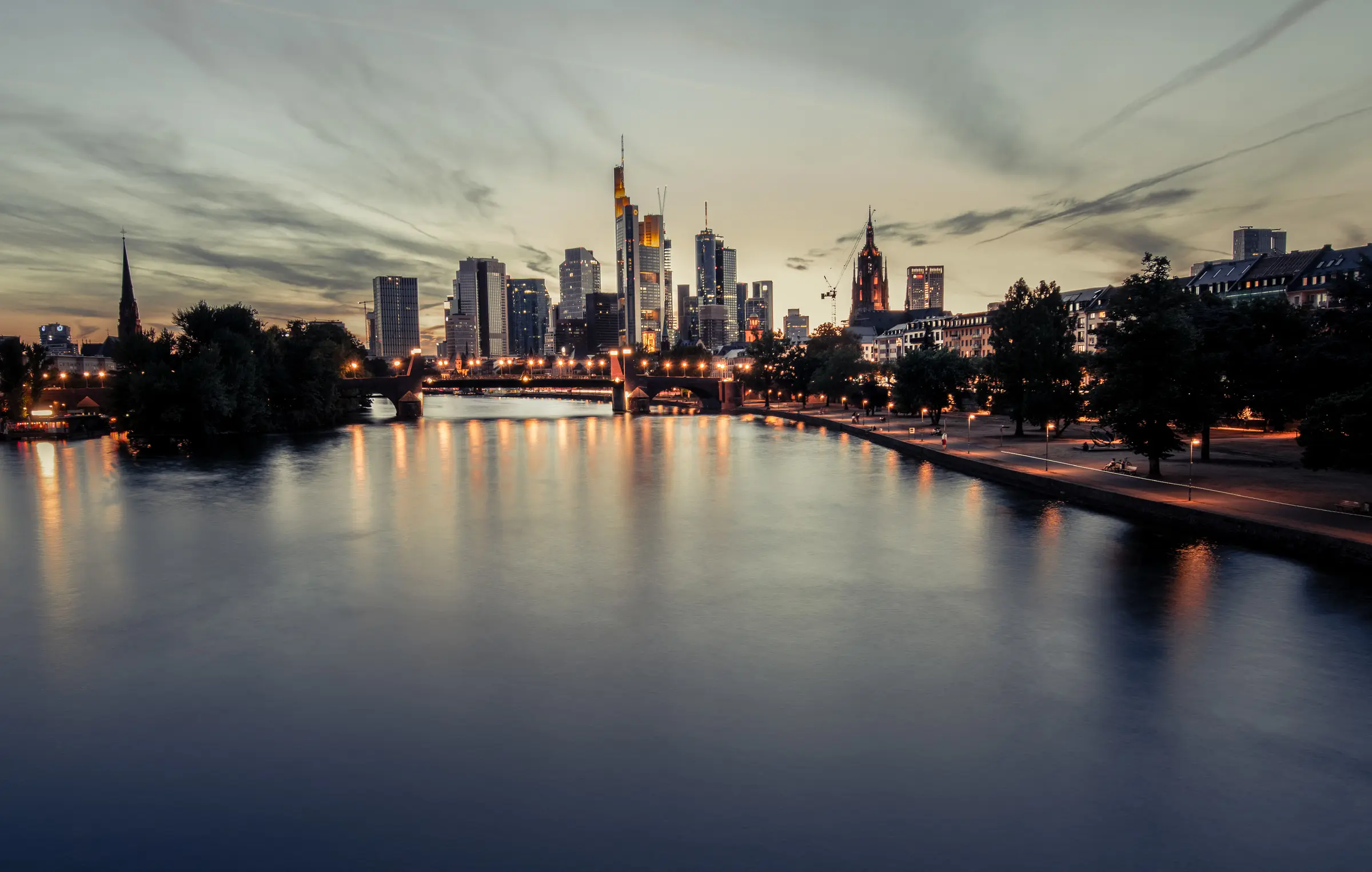 The Frankfurt skyline at dusk, reflected in the river Main