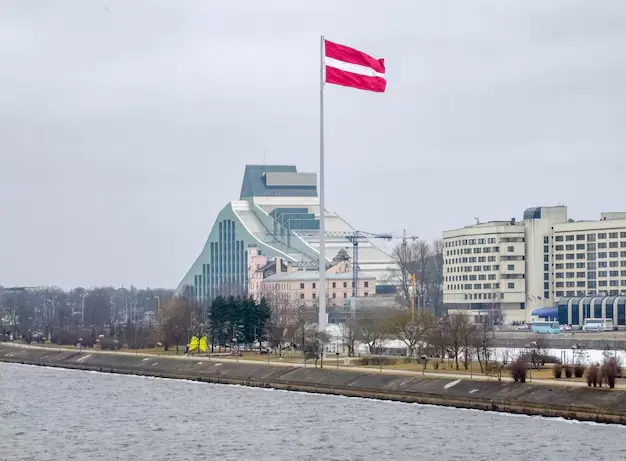 The Austrian flag flying over a riverside skyline